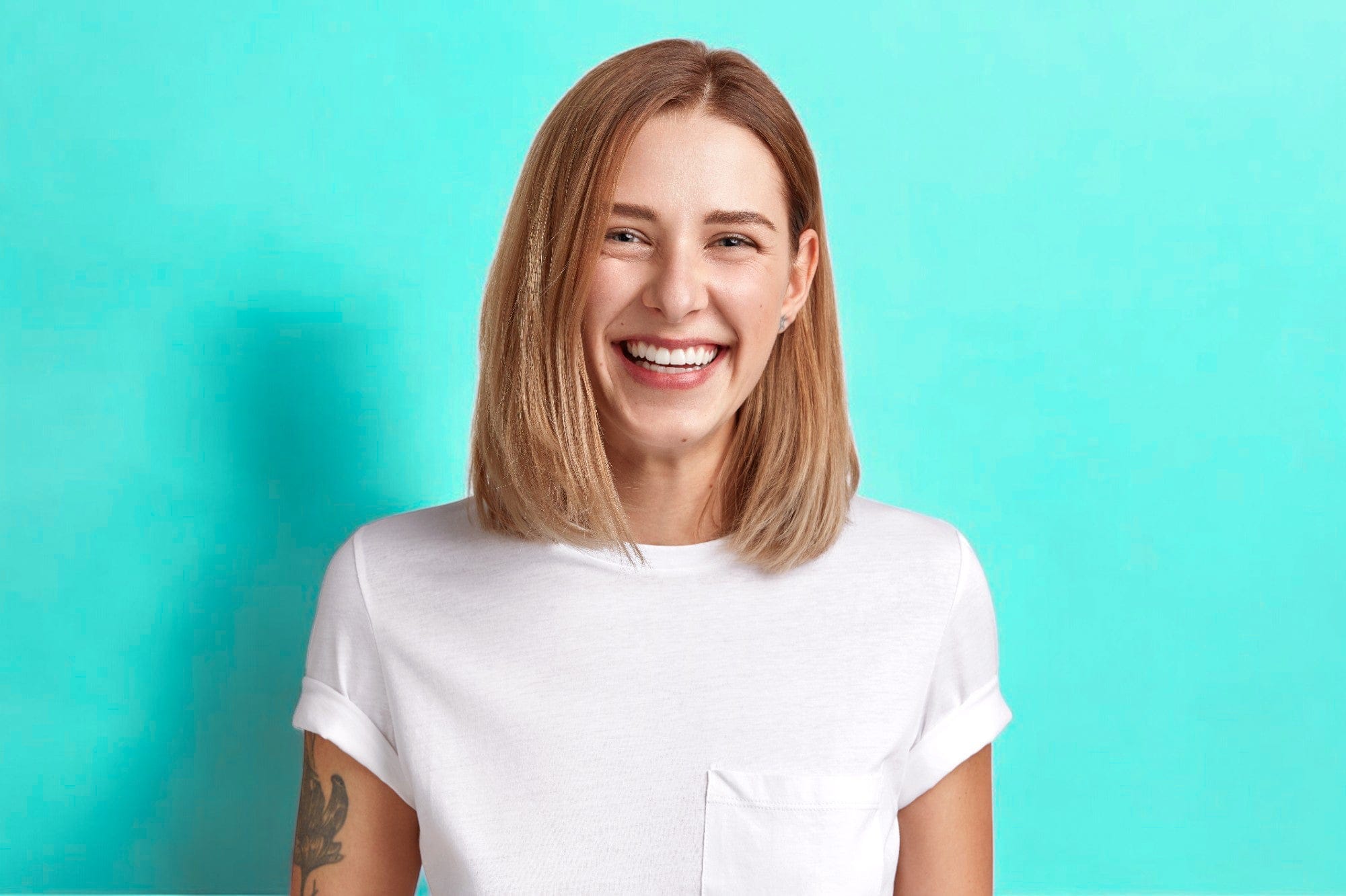 Smiling woman in white shirt.